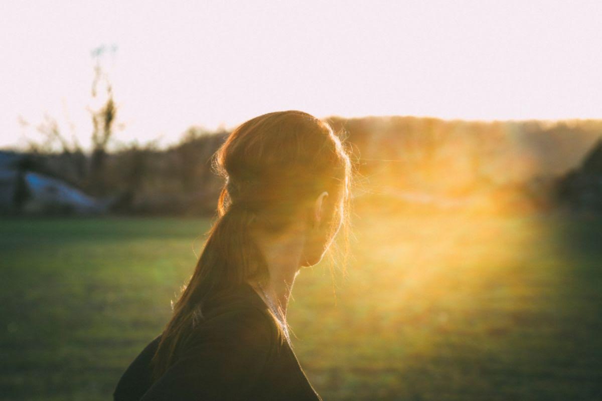 What is human flourishing? Woman stares into the late afternoon sky, contemplating her next move.